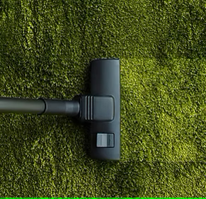 top-view-of-vacuum-cleaner-cleaning-green-carpet